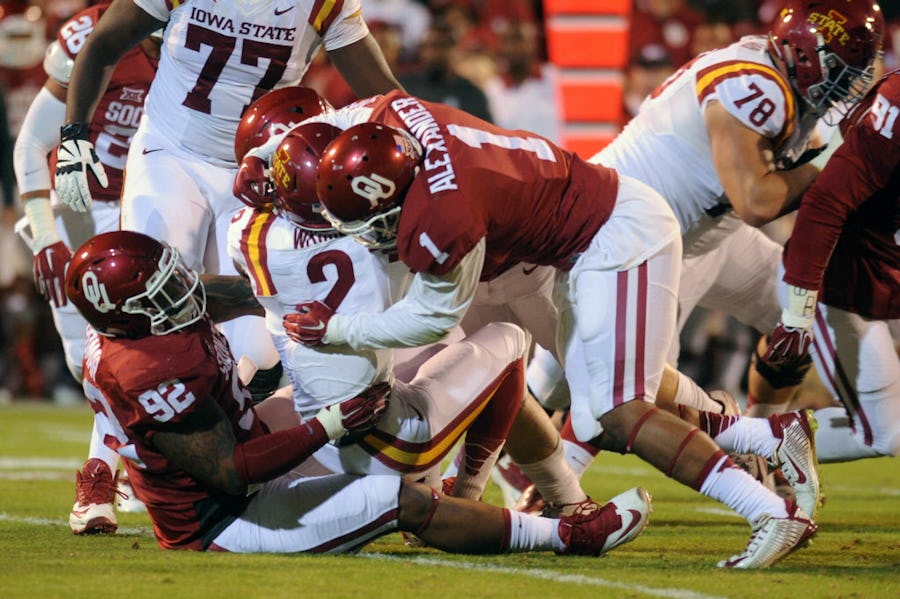 Nov 7, 2015; Norman, OK, USA; Iowa State Cyclones running back Mike Warren (2) is tackled by Oklahoma Sooners linebacker Dominique Alexander (1) and Matt Romar (92) during the first quarter at Gaylord Family - Oklahoma Memorial Stadium. Mandatory Credit: Mark D. Smith-USA TODAY Sports