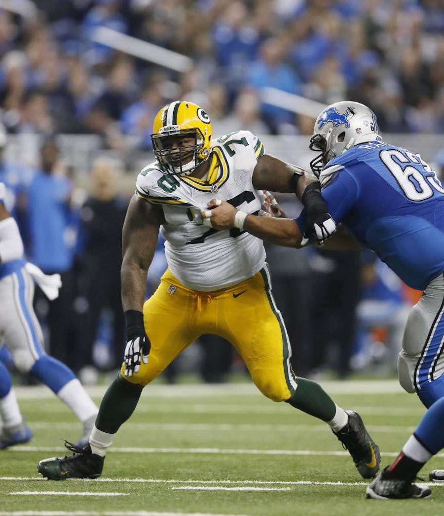 Green Bay Packers defensive end Mike Daniels (76) goes up against Detroit Lions guard Manny Ramirez (63) during the first half of an NFL football game, Thursday, Dec. 3, 2015, in Detroit. (AP Photo/Duane Burleson)