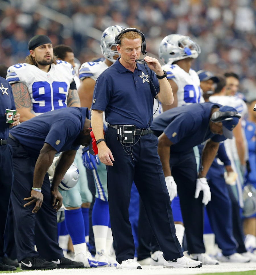 At times, the Dallas Cowboys staff, including head coach Jason Garrett (center), couldn't bear to watch their offense play in the fourth quarter against the Washington Redskins at AT&T Stadium in Arlington, Texas, Sunday, January 3, 2016. The Cowboys lost 34-23.