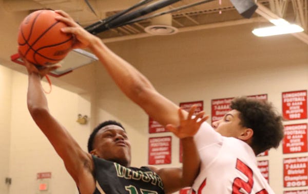 Cedar Hill center Zach Simmons (24) blocks a shot by Desoto guard Morris Coe (15) during first half action. The two teams played their District 8-6A basketball game at Cedar Hill High School on January 15, 2016. (Steve Hamm/Special Contributor)