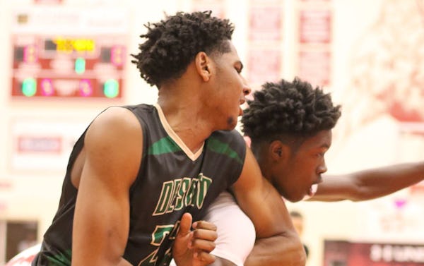 DeSoto post Marques Bolden (22) battles with Cedar Hill forward Lesley Varner (11) for rebound position during the game's initial drive. Both players were given a warning by a referee for the physical play. The two teams played their District 8-6A basketball game at Cedar Hill High School on January 15, 2016. (Steve Hamm/Special Contributor)