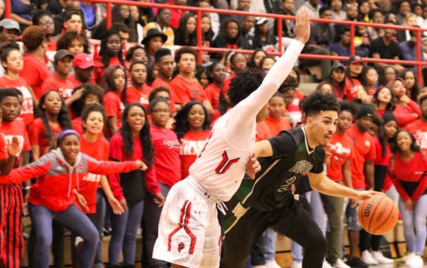 DeSoto guard Julian Miranda (2) drives to the basket past the defense of Cedar Hill guard Jairus Adley (5) and the vocal support of the Longhorns student section during first half action. The two teams played their District 8-6A basketball game at Cedar Hill High School on January 15, 2016. (Steve Hamm/Special Contributor)