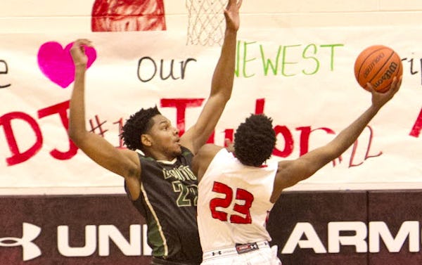 DeSoto post Margues Bolden (22) makes his presence known defensively as Cedar Hill forward Terrence Jones (23) drives the lane to put up a shot during first half action. The two teams played their District 8-6A basketball game at Cedar Hill High School on January 15, 2016. (Steve Hamm/Special Contributor)