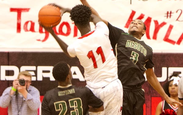Cedar Hill forward Lesley Varner (11) drives the lane offensively as DeSoto guard Jordan Berry (3) defends during first half action. The two teams played their District 8-6A basketball game at Cedar Hill High School on January 15, 2016. (Steve Hamm/Special Contributor)