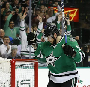 Dallas Stars center Tyler Seguin (91) celebrates Johnny Oduya's goal in the first period against Carolina Hurricanes goalie Cam Ward (30) at the American Airlines Center in Dallas, Tuesday, December 8, 2015. (Tom Fox/The Dallas Morning News)