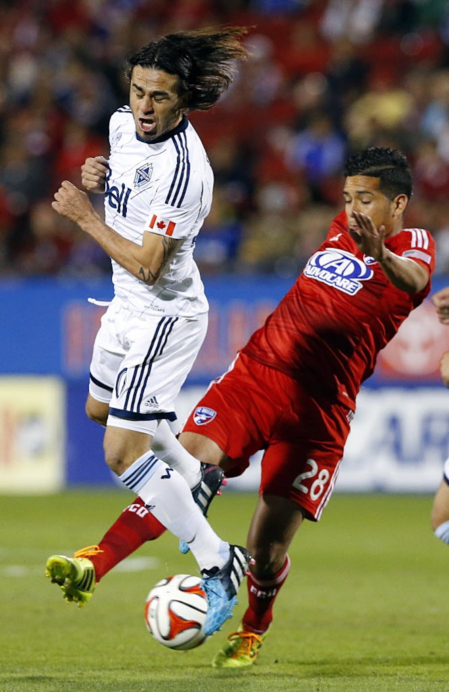 Vancouver Whitecaps FC midfielder Mauro Rosales (30) tries to block a shot by FC Dallas midfielder Victor Ulloa (28) in the first half of their MLS playoff game at Toyota Stadium, Wednesday, October 29, 2014. (Tom Fox/The Dallas Morning News)