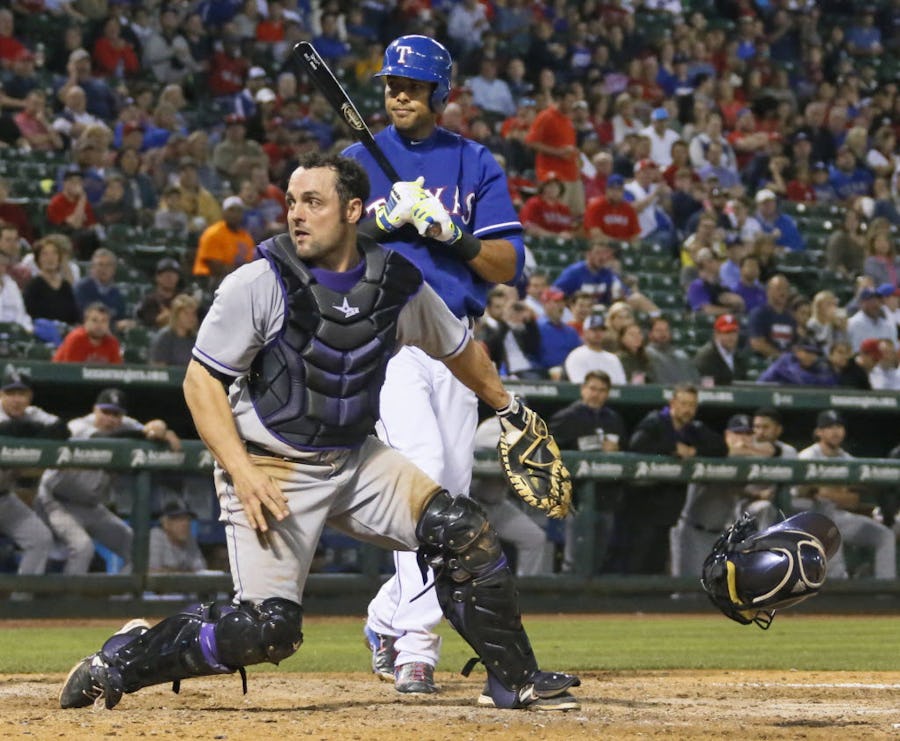 Rockies catcher Michael McKenry chases after a wild pitch in the seventh inning with Alex Rios batting, which allowed Shin-Soo Choo to score, during the Colorado Rockies vs. the Texas Rangers major league baseball game at Globe Life Park in Arlington, Texas on Thursday, May 8, 2014.