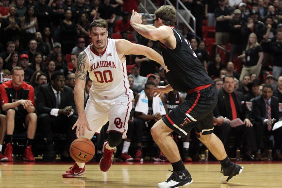 Feb 17, 2016; Lubbock, TX, USA; Oklahoma Sooners forward Ryan Spangler (00) works the ball around Texas Tech Red Raiders forward Matthew Temple (34) in the first half at United Supermarkets Arena. Mandatory Credit: Michael C. Johnson-USA TODAY Sports