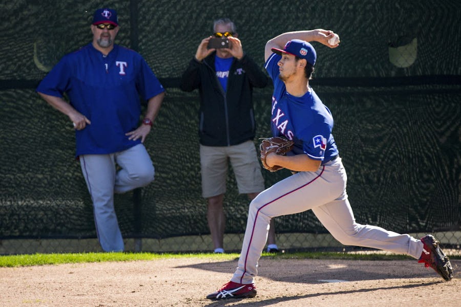 Texas Rangers pitcher Yu Darvish throws from a half pitching mound under eye of Rangers pitching coach Doug Brocail (left) during a spring training workout at the team's training facility on Monday, Feb. 22, 2016, in Surprise, Ariz. (Smiley N. Pool/The Dallas Morning News)