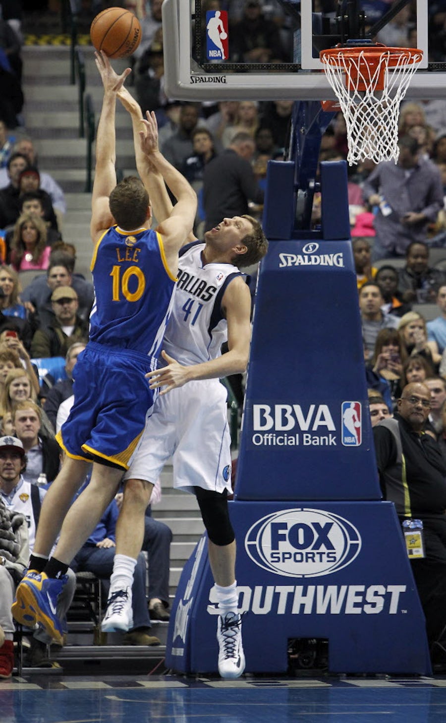 Dallas Mavericks power forward Dirk Nowitzki (41) blocks the shot of Golden State Warriors power forward David Lee (10) in the first half of NBA Basketball action at the American Airlines Center in Dallas, Texas on Wednesday, November 27, 2013.   (Brad Loper/The Dallas Morning News)