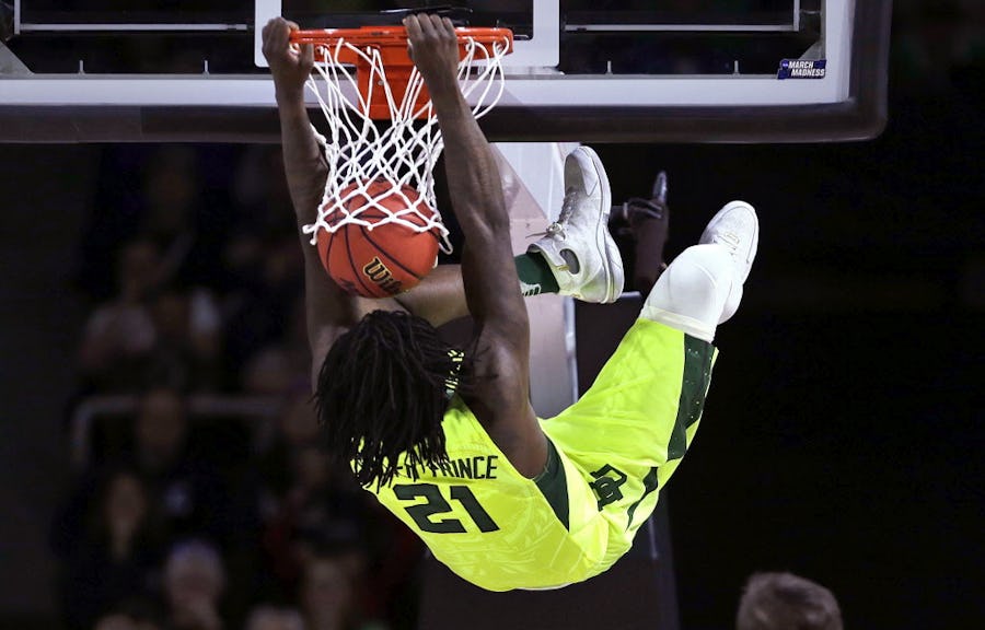 Baylor forward Taurean Prince hangs from on a dunk against Yale during the first half in the first round of the NCAA college men's basketball tournament in Providence, R.I., Thursday, March 17, 2016. Prince was charged with a technical foul on the play. (AP Photo/Charles Krupa)