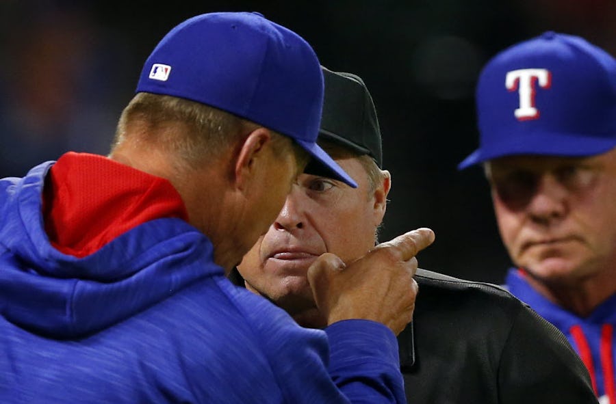 Texas Rangers manager Jeff Banister (left) has words with home plate umpire Marvin Hudson after his relief pitcher Tom Wilhelmsen was tossed out after hitting Seattle Mariners batter Chris Iannetta in the eighth inning at Globe Life Park in Arlington, Tuesday, April 5, 2016. (Tom Fox/The Dallas Morning News)