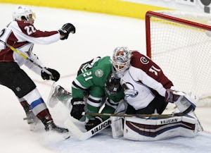 Dallas Stars left wing Antoine Roussel (21) runs into Colorado Avalanche goalie Calvin Pickard (31) as Colorado Avalanche defenseman Zach Redmond (22) follows during the second period of play at American Airlines Center in Dallas on Thursday, April 7, 2016. (Vernon Bryant/The Dallas Morning News)