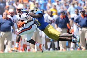 September 5, 2015; Pasadena, CA, USA; Virginia Cavaliers running back Olamide Zaccheaus (33) runs the ball against the defense of UCLA Bruins linebacker Myles Jack (30) during the first half at the Rose Bowl. Mandatory Credit: Gary A. Vasquez-USA TODAY Sports ORG XMIT: USATSI-226142