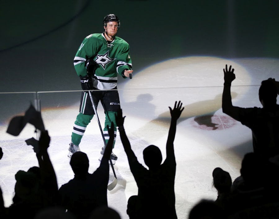 Dallas Stars center Radek Faksa (12) tosses his puck into the crowd after being recognized as one of Stars of Game 1 against the Minnesota Wild at the American Airlines Center in Dallas,Thursday, April 14, 2016. The Stars shutout the Wild, 4-0. (Tom Fox/The Dallas Morning News)