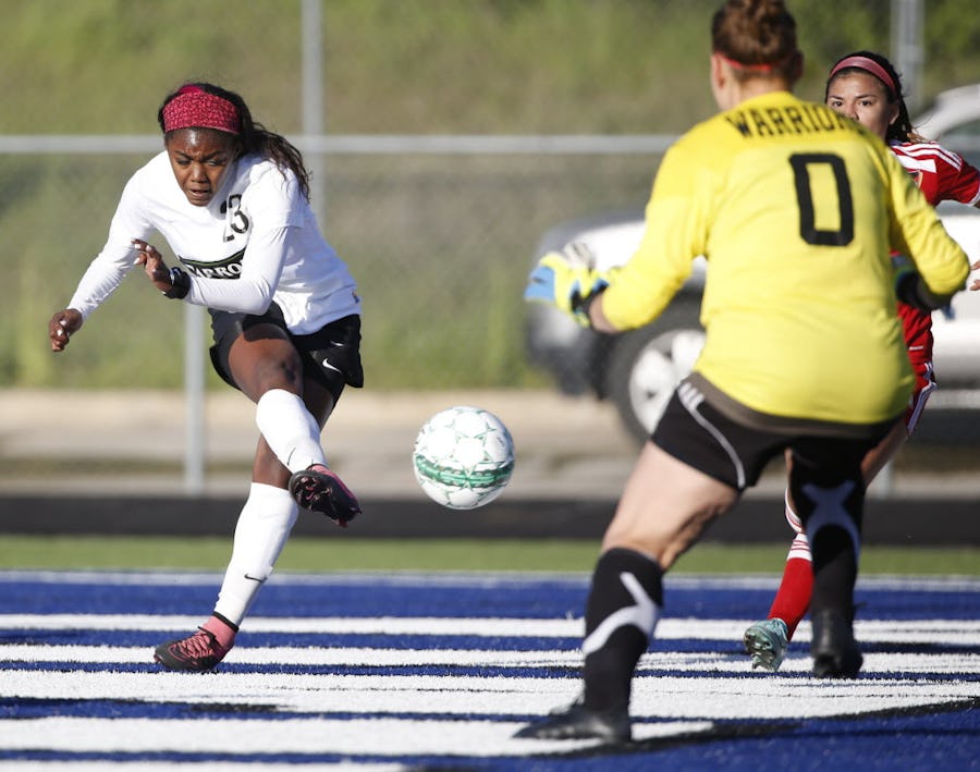 Southlake Carroll forward Ally Griffin (23) scores a goal against South Grand Prairie keeper Alexis Tipps in the first half of the girls class 6A first-round playoff game at Doskocil Stadium at Nolan Catholic High School in Fort Worth, Texas on March 24, 2016. Southlake Carroll defeated South Grand Prairie 10-0.
