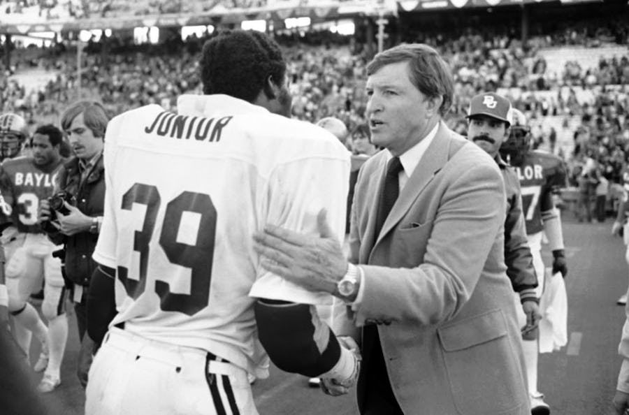 FILE - In this Jan. 1, 1981, file photo, Baylor head football coach Grant Teaff, right, congratulates Alabama defensive end E.J. Junior after Alabama's 30-2 victory over his team in the Cotton Bowl college football game in Dallas. Two decades after his last game, Teaff is feeling emotional about Floyd Casey Stadium which the No. 9 Bears will close Saturday, Dec. 7, 2013, after 64 seasons, in a finale against No. 23 Texas when they can clinch at least a share of their first Big 12 title. (AP Photo/Bill Haber, File)