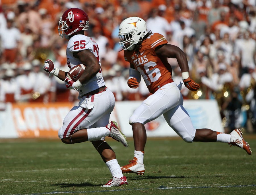 Oklahoma Sooners running back Joe Mixon (25) rushes the ball while being defended by Texas Longhorns linebacker Malik Jefferson (46) in the second quarter during an NCAA football game between Oklahoma and Texas at the Cotton Bowl in Dallas Saturday October 10, 2015. Texas Longhorns beat Oklahoma Sooners 24-17. (Andy Jacobsohn/The Dallas Morning News)