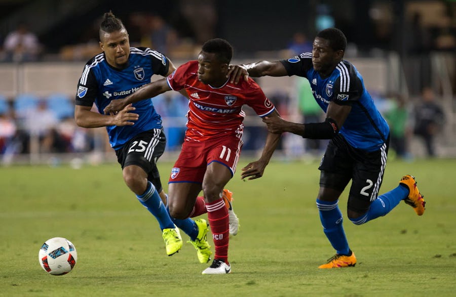 May 28, 2016; San Jose, CA, USA; FC Dallas forward Fabian Castillo (11) controls the ball between San Jose Earthquakes forward Quincy Amarikwa (25) and defender Kofi Sarkodie (2) during the second half at Avaya Stadium. The San Jose Earthquakes and FC Dallas tied 0-0. Mandatory Credit: Kelley L Cox-USA TODAY Sports