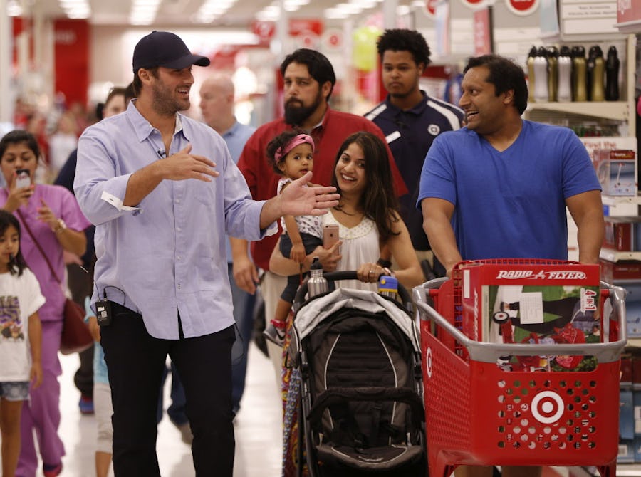 Dallas Cowboys quarterback Tony Romo (from left) talks to Amara Datta, 19 months, Jeet Datta and Rakhi Rao during a suprise fathers day trip to Target for Father's Day in  Dallas, Texas June 15, 2016.  (Nathan Hunsinger/The Dallas Morning News)