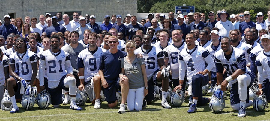 Head coach Jason Garrett and his wife Brill Garrett pose front and center with Dallas Cowboys players and coaches taking a group photograph after the team's final practice at Valley Ranch on Thursday, June 16, 2016, in Irving, Texas. (Jae S. Lee/The Dallas Morning News)