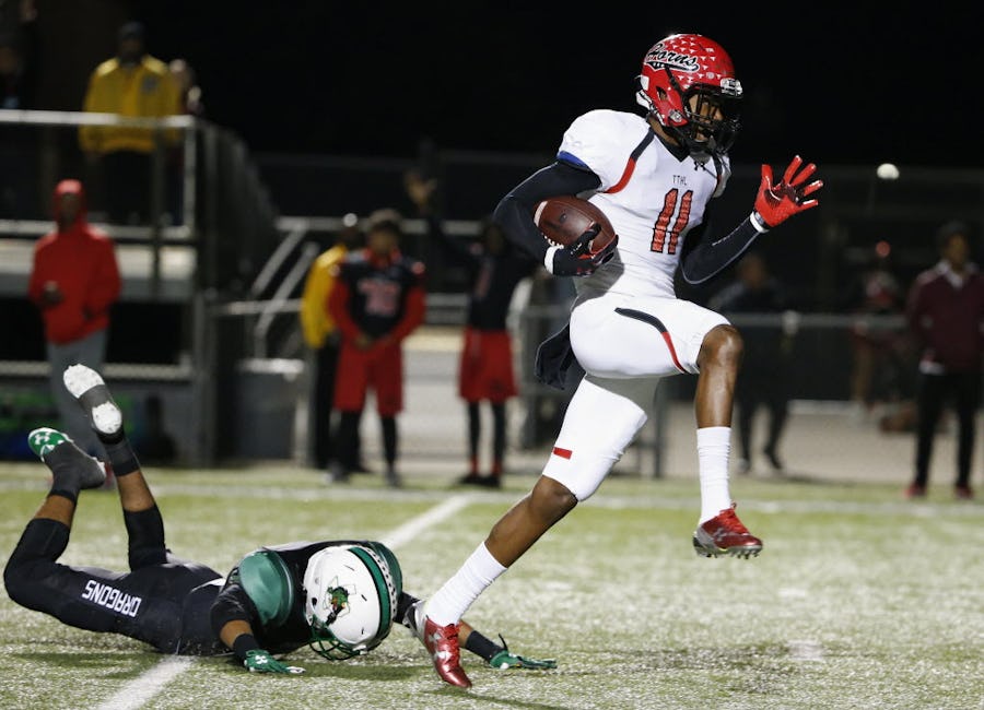 Cedar Hill wide receiver Charleston Rambo (11) scores a receiving touchdown to make the score 13-21 while avoiding a tackle by Southlake Carroll defensive back Zion Salaes (21) in the second quarter during a 6A Division II Region 1 bi-district high school football playoff game between Cedar Hill and Southlake Carroll at Dragon Stadium in Southlake, Texas Friday November 13, 2015. (Andy Jacobsohn/The Dallas Morning News)