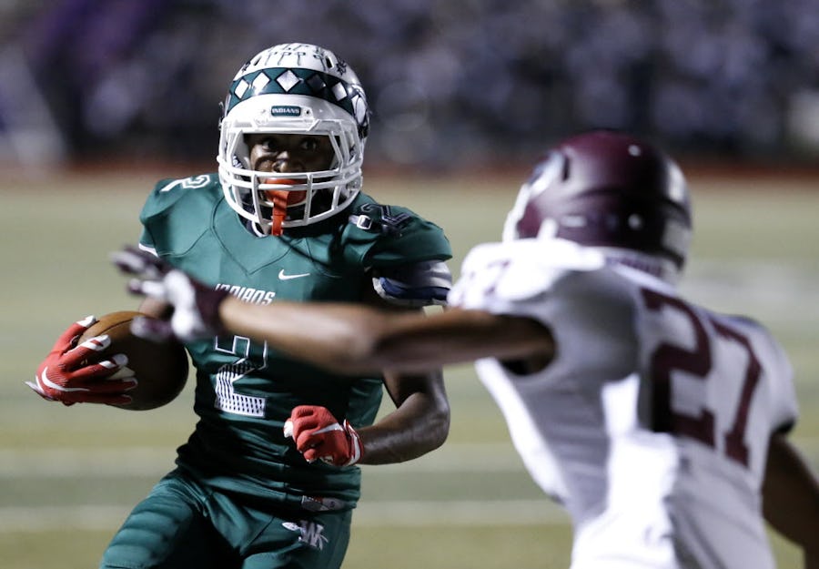 Waxahachie receiver Kenedy Snell (2) attempts to make a run past Ennis corner back Marqus Monroe (27) in the second half of the game between Waxahachie High School and Ennis High School at Lumpkins Stadium in Waxahachie, Texas on Sept. 11, 2015. (Rose Baca/The Dallas Morning News)