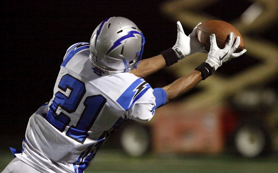 Dallas Christian School wide receiver Justis Nelson (21) pulls in this long pass for a net gain of more than 60 yards and a touchdown to tie the score at 7-7 after the extra point attempt against Parish Episcopal School in the first quarter at Parish Episcopal School Stadium in Dallas on Friday night, October 5, 2012. (Stewart F. House/Special Contributor)