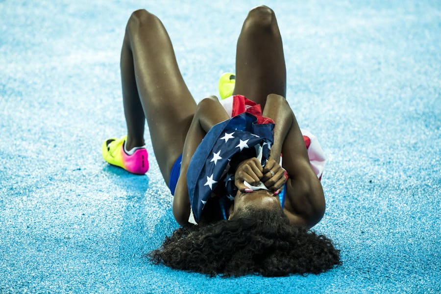 Ashley Spencer of the United States collapses to the track clutching the American flag after winning the bronze medal in the women's 400m hurdles final at the Rio 2016 Olympic Games on Thursday, Aug. 18, 2016, in Rio de Janeiro. (Smiley N. Pool/The Dallas Morning News)