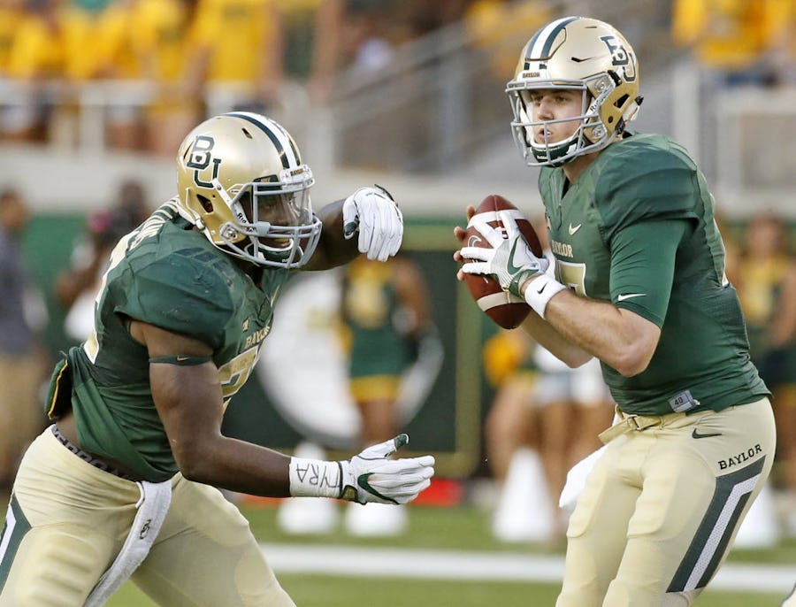 Baylor quarterback Seth Russell (17), right, fakes a handoff to running back Terence Williams (22) in the first quarter during the Northwestern State University Demons vs. the Baylor University Bears NCAA football game at McLane Stadium in Waco, Texas on Friday, September 2, 2016. (Louis DeLuca/The Dallas Morning News)