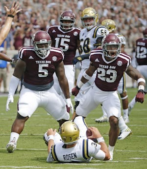 Texas A&M defensive lineman Daylon Mack (5) and defensive back Armani Watts (23) celebrate sacking UCLA quarterback Josh Rosen in the first quarter during the UCLA Bruins vs. the Texas A&M Aggies NCAA football game at Kyle Field in College Station, Texas on Saturday, September 3, 2016. (Louis DeLuca/The Dallas Morning News)