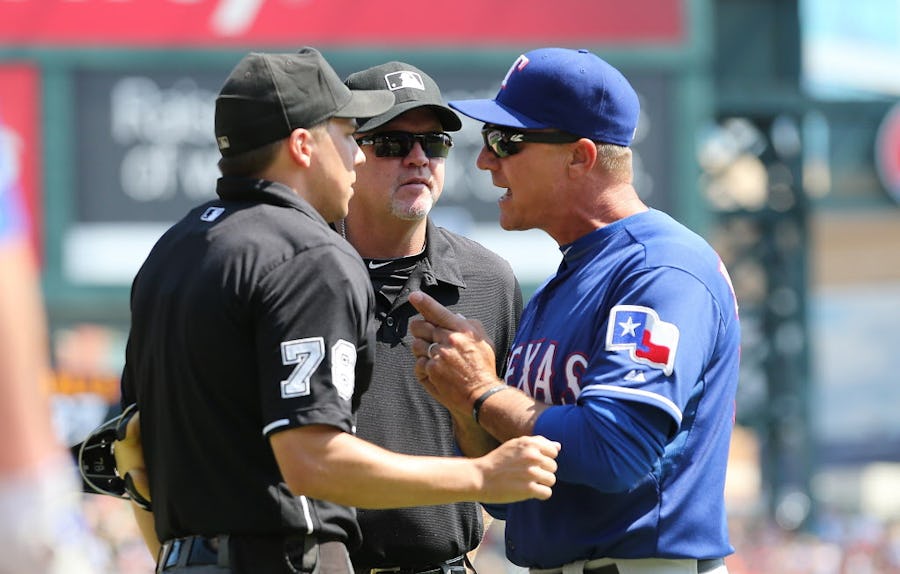 u00a0Texas Rangers manager Jeff Banister #28 argues with umpires Adam Hamari and Ron Kupla after third baseman Adrian Beltre #29 (not in photo) was thrown out of the game during the fifth inning of the game against the Detroit Tigers on August 23, 2015 at Comerica Park in Detroit, Michigan. (Photo by Leon Halip/Getty Images)