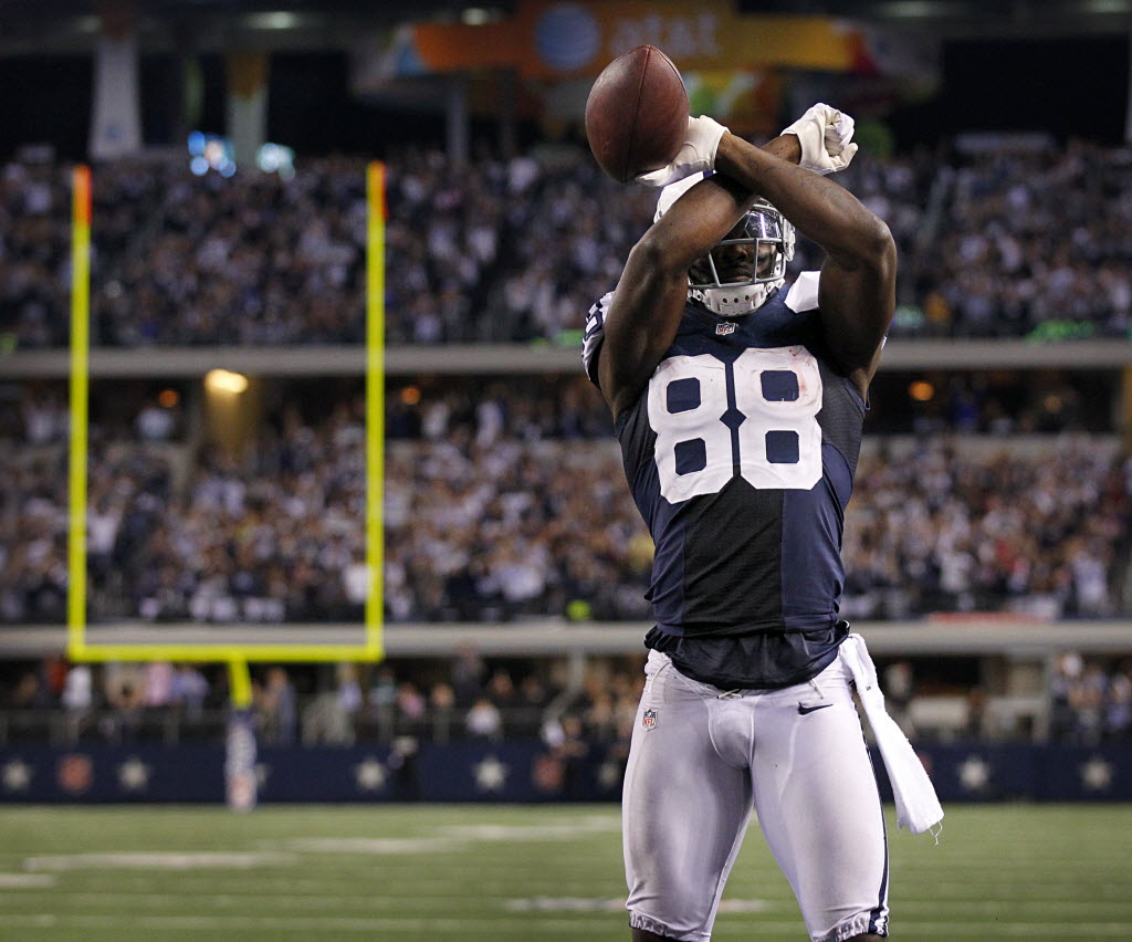 The Dallas Cowboys' Brandon Carr, left, looks on as teammate Dez Bryant  looks to the replay and shows his frustration after being penalized for  interference and removing his helmet late in the