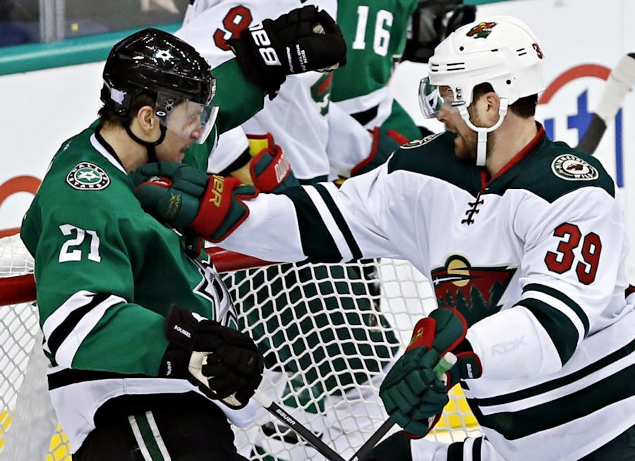 Minnesota Wild defenseman Nate Prosser (39) shoves Dallas Stars left wing Antoine Roussel at the goal during the third period of the Stars' 2-1 loss Saturday, November 15, 2014 at the American Airlines Center in Dallas, Texas. (G.J. McCarthy/The Dallas Morning News)