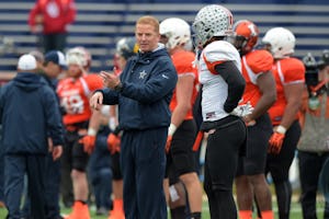 Jan 27, 2016; Mobile, AL, USA; North squad head coach Jason Garrett of the Dallas Cowboys talks with wide receiver Braxton Miller of Ohio State (right) during Senior Bowl practice at Ladd-Peebles Stadium. Mandatory Credit: Glenn Andrews-USA TODAY Sports