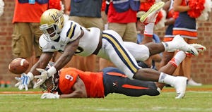 UCLA linebacker Myles Jack almost comes up with an interception in front of Virginia receiver Canaan Severin at Scott Stadium in Charlottsville, Va., on Saturday, Aug. 30, 2014. UCLA won, 28-20. (Wally Skalij/Los Angeles Times/MCT) 09122014xSPORTS