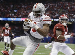 Ohio State wide receiver Michael Thomas (3) makes a touchdown catch against Alabama defensive back Cyrus Jones (5) in the first half of the Sugar Bowl NCAA college football playoff semifinal game, Thursday, Jan. 1, 2015, in New Orleans. (AP Photo/Brynn Anderson)