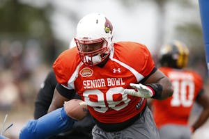 Louisville defensive end Sheldon Rankins (98) runs through drills during NCAA college football practice for the Senior Bowl, Tuesday, Jan. 26, 2016, at Fairhope Municipal Stadium, in Fairhope, Ala.(AP Photo/Brynn Anderson)