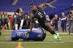 UCLA defensive lineman Kenny Clark runs a drill at the NFL football scouting combine in Indianapolis, Sunday, Feb. 28, 2016. (AP Photo/Michael Conroy)