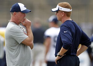 Dallas Cowboys vice president Stephen Jones talks with Dallas Cowboys head coach Jason Garrett during the morning walk through at Dallas Cowboys training camp in Oxnard, California on August 2, 2013. (Vernon Bryant/The Dallas Morning News)
