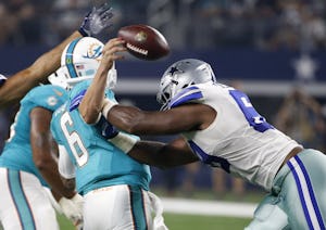 Miami Dolphins quarterback Brandon Doughty (6) fumbles the ball after being hit by Dallas Cowboys' Shaneil Jenkins in the first half of an NFL preseason football game, Friday, Aug. 19, 2016, in Arlington, Texas. The Cowboys recovered the fumble. (AP Photo/Ron Jenkins)