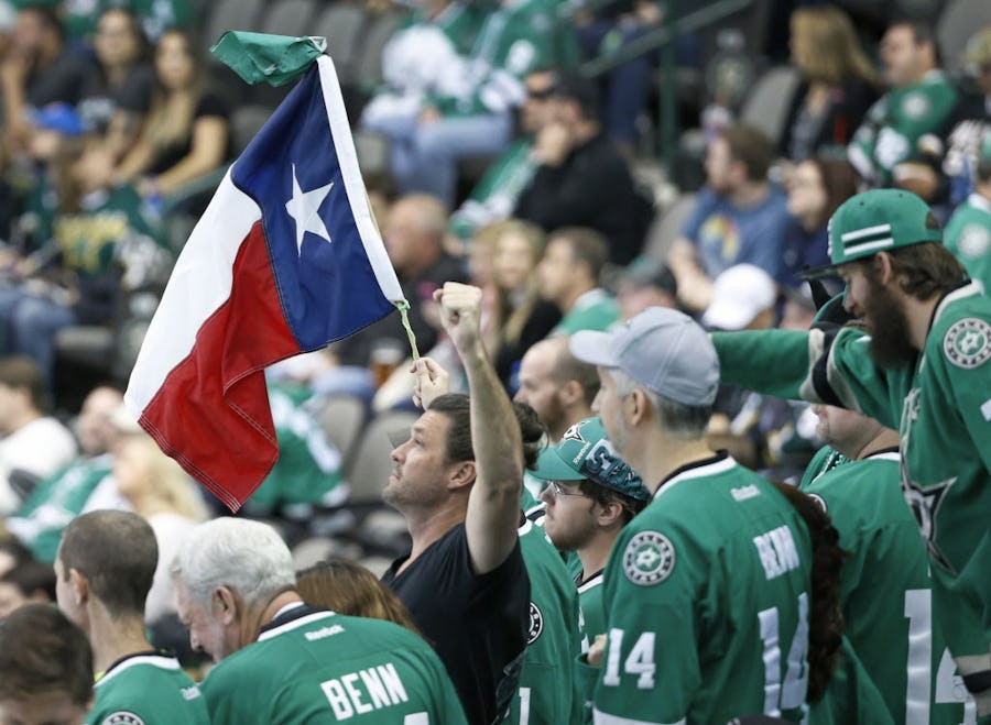 Dallas Stars fans wave a Texas flag as the clock winds down in the third period during the Anaheim Ducks vs. the Dallas Stars NHL hockey game at the American Airlines Center on Thursday, October 13, 2016. (Louis DeLuca/The Dallas Morning News)