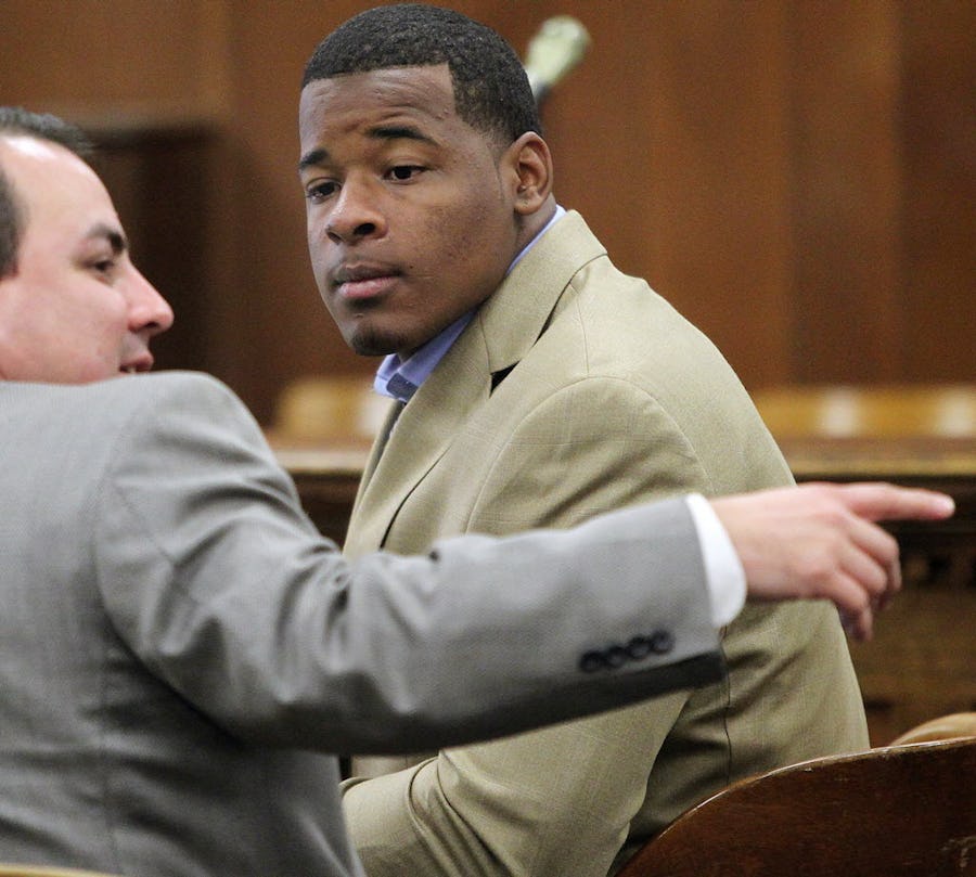 FILE - In this Jan. 23, 2014, file photo, former Baylor football player Tevin Elliott waits with a unidentified lawyer in a McLennan county courtroom in Waco, Texas. A woman has filed a federal lawsuit against Baylor University contending that the largest Baptist school in the country was deliberately indifferent to sexual assault allegations against a former football player. The lawsuit alleges that Baylor failed to act against Tevin Elliott despite receiving six complaints from women claiming he assaulted them. (Jerry Larson/Waco Tribune Herald via AP, File)