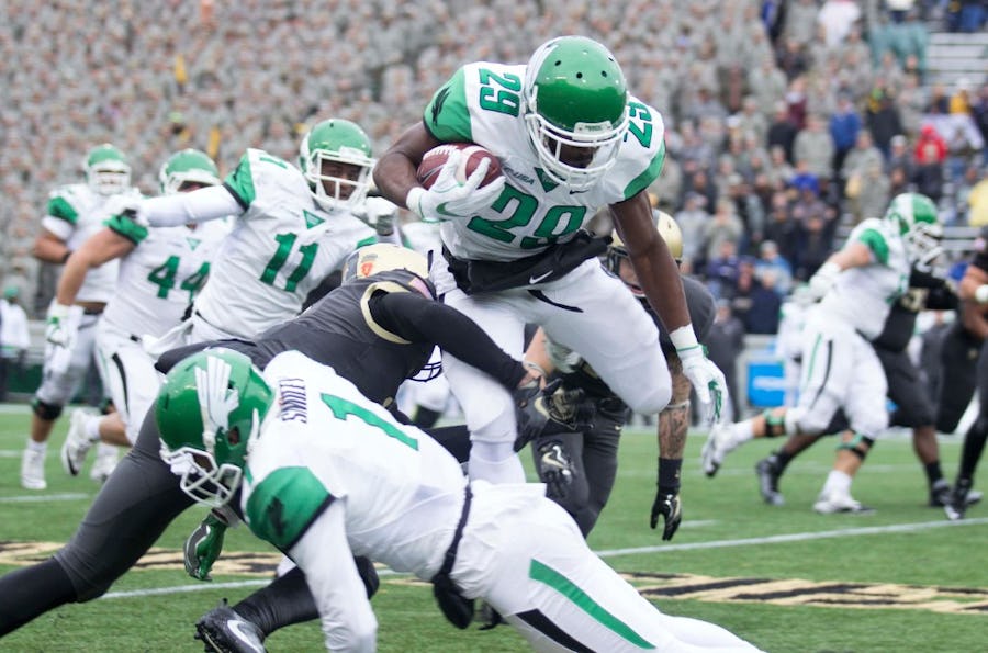 North Texas running back Willy Ivery hurdles a defender in their win against Army at Michie Stadium in West Point, NY. (Josh Conklin/For The Times Herald-Record)