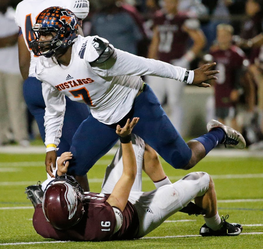 Sachse linebacker Riko Jeffers (7) hovers over Rowlett quarterback Preston Weeks (16) after applying a hard hit as Weeks threw a pass in the fourth quarter during the Sachse High School Mustangs vs. the Rowlett High School Eagles football game at Homer B. Johnson Stadium in Garland, Texas on Friday, October 21, 2016. (Louis DeLuca/The Dallas Morning News)