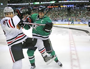 Chicago Blackhawks right wing Ryan Hartman (38) and Dallas Stars left wing Jamie Benn (14) mix it up in front of the benches in the first period during the Chicago Blackhawks vs. the Dallas Stars NHL hockey game at the American Airlines Center in Dallas on Saturday, November 5, 2016. (Louis DeLuca/The Dallas Morning News)