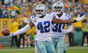 Dallas Cowboys strong safety Barry Church (42) celebrates his interception with teammate Anthony Brown (30) during the Dallas Cowboys vs. the Green Bay Packers NFL football game at Lambeau Field in Green Bay, Wisconsin, on Sunday, October 16, 2016. (Louis DeLuca/The Dallas Morning News)
