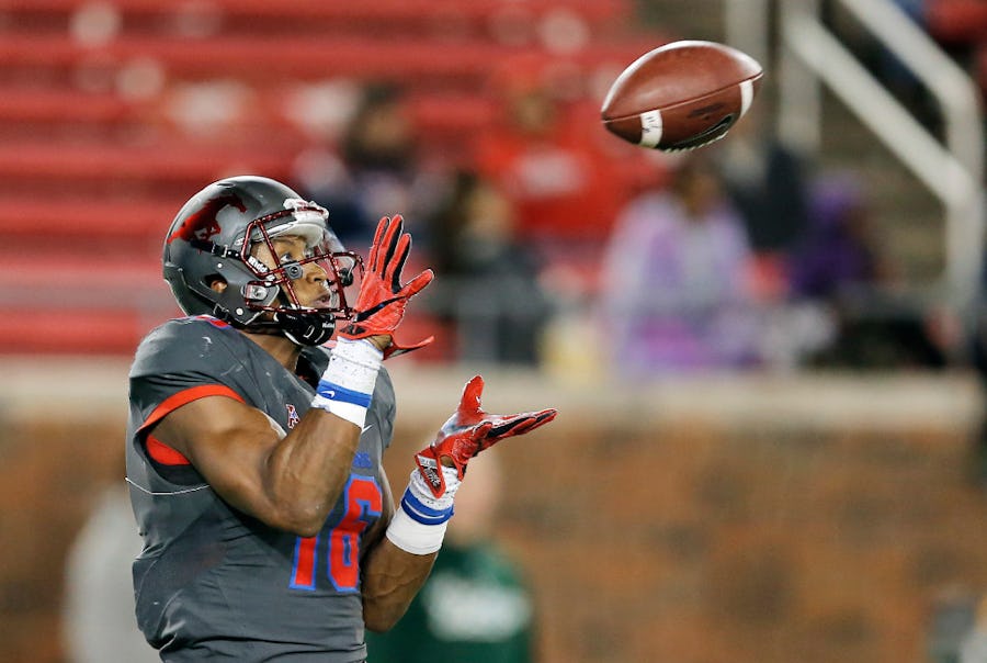 SMU wide receiver Courtland Sutton (16) catches a pass during the second half of an NCAA college football game Saturday, Nov. 19, 2016, in Dallas. Sutton ran the ball in for a touchdown on the play. South Florida won 35-27. (AP Photo/Brandon Wade)