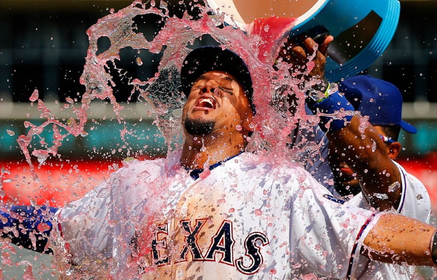 Texas Rangers left fielder Carlos Gomez relishes the sports drink dump by teammate Elvis Andrus following his grand slam performance against the Seattle Mariners at Globe Life Park in Arlington, Wednesday, August 31, 2016.  The Rangers won 14-1. (Tom Fox/The Dallas Morning News)