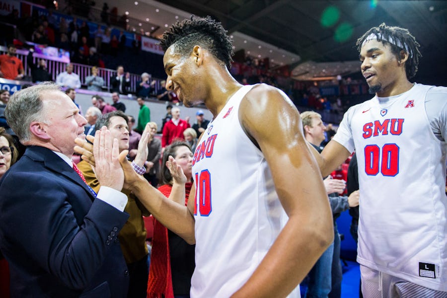 Southern Methodist Mustangs guard Jarrey Foster (10) and Southern Methodist Mustangs forward Ben Moore (0) high five fans after their 74-59 win over the TCU Horned Frogs on Wednesday, December 7, 2016 at Moody Coliseum on the SMU campus in Dallas. (Ashley Landis/The Dallas Morning News)